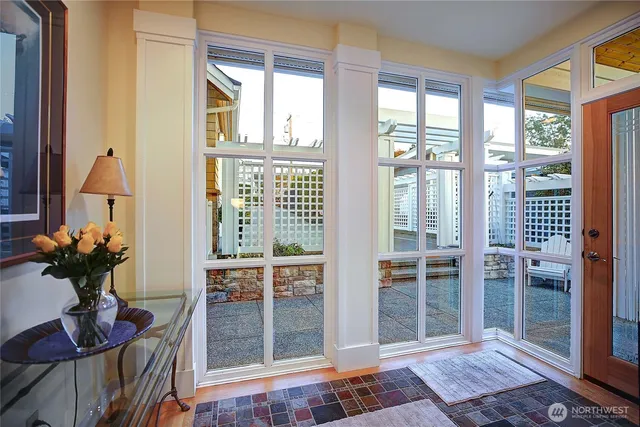 a living room with furniture a fireplace and a large window