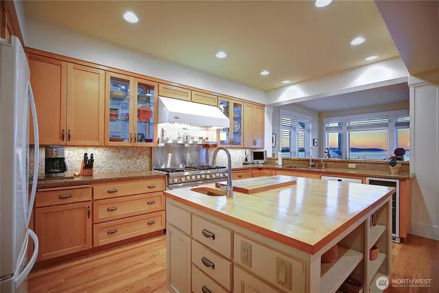 a kitchen with stainless steel appliances granite countertop a stove and a sink