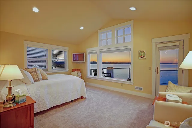 a bedroom with bed and a large window