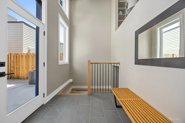 a view of a bedroom with wooden floor and windows