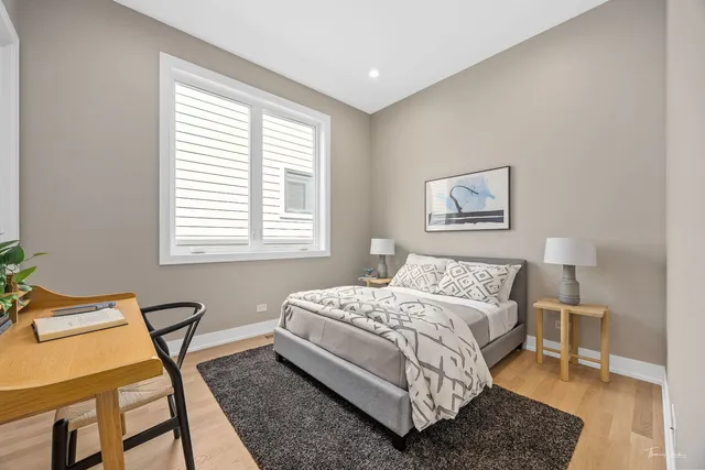 a bedroom with a bed a table and chair