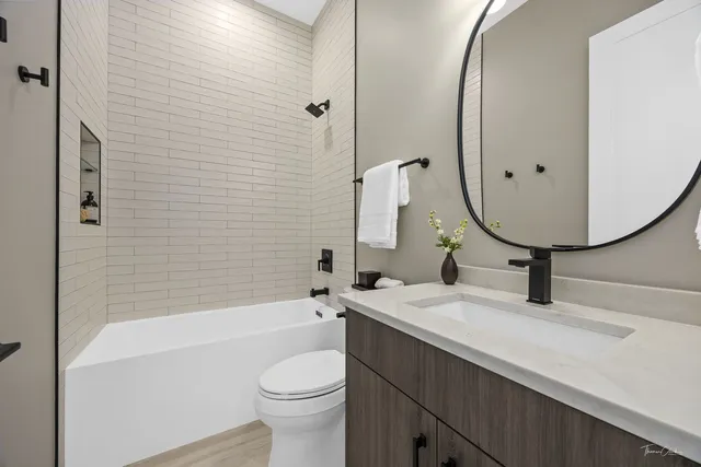 a bathroom with a sink a toilet and a mirror