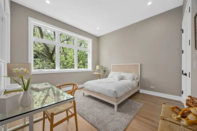 a living room with a bed furniture and a large window
