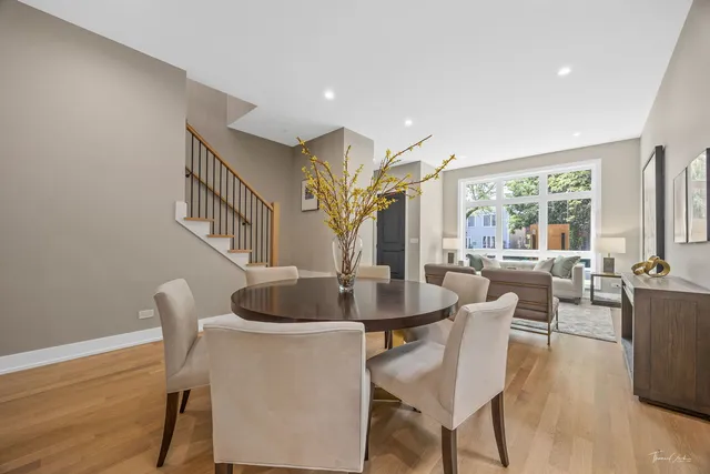 a dining room with furniture window and wooden floor