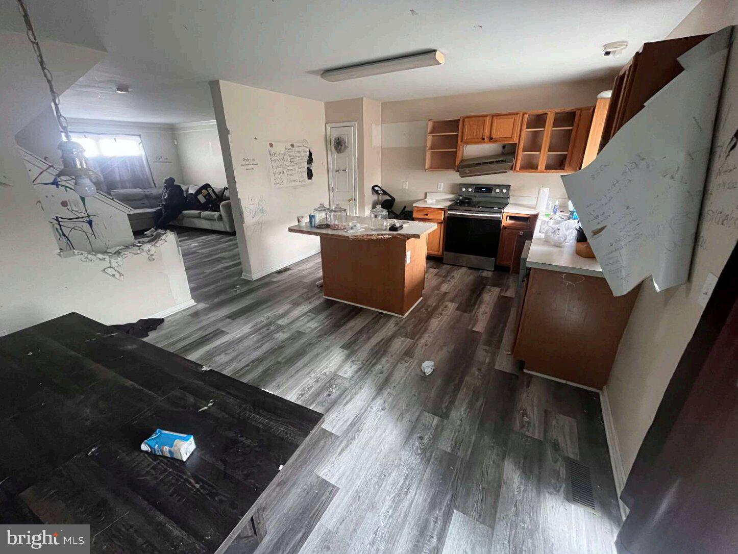 54 Lisa Drive Newark, DE 19702 - Photo 5 of 8 a kitchen with stainless steel appliances kitchen island granite countertop a stove a refrigerator a sink and dishwasher with wooden floor