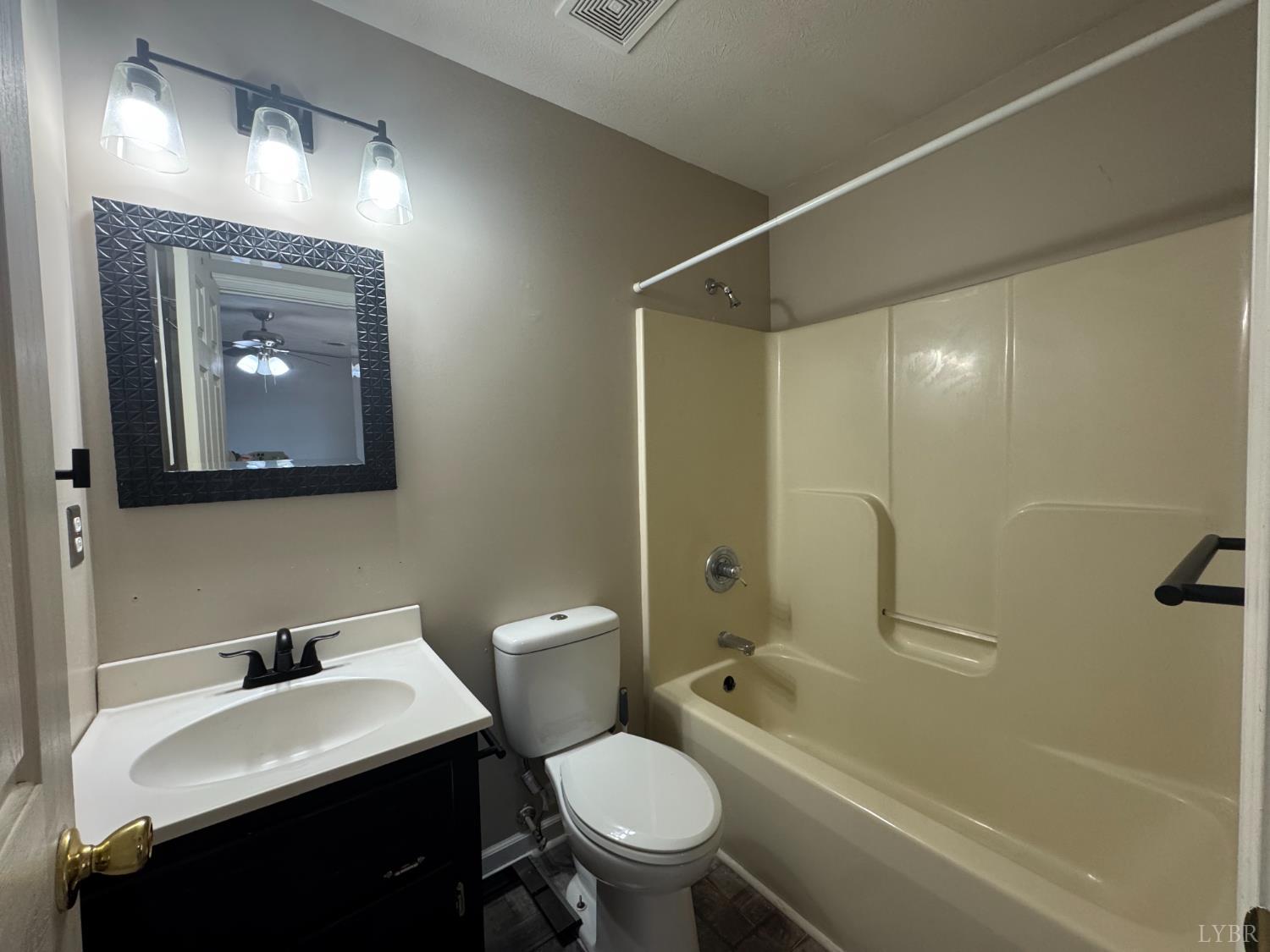 3363 Horseshoe Road Appomattox, VA 24522 - Photo 12 of 15 a bathroom with a toilet a sink and a bathtub