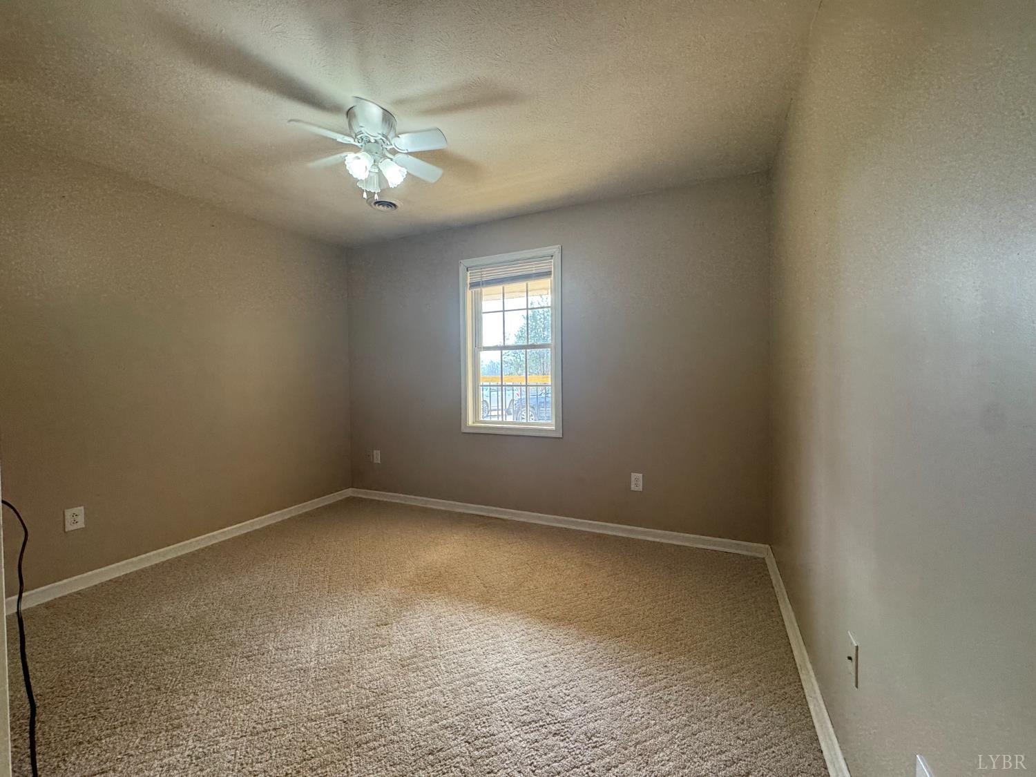3363 Horseshoe Road Appomattox, VA 24522 - Photo 8 of 15 an empty room with a ceiling fan and window