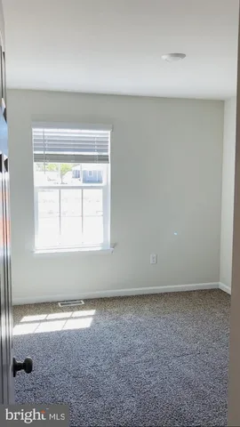 a bathroom with a granite countertop sink mirror vanity and toilet