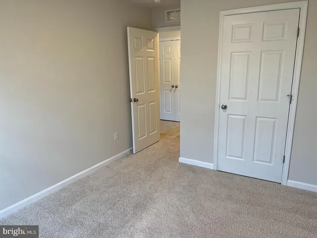 an empty room with closet area