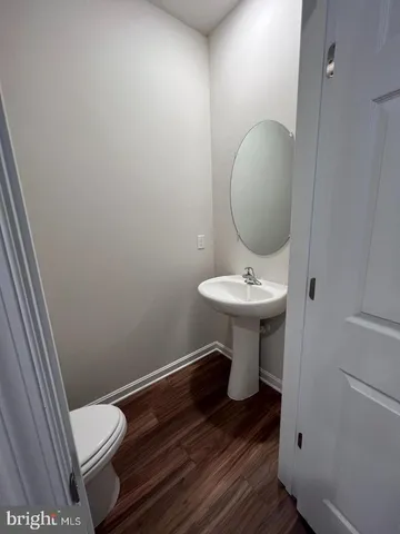 a bathroom with a granite countertop toilet a sink and a shower
