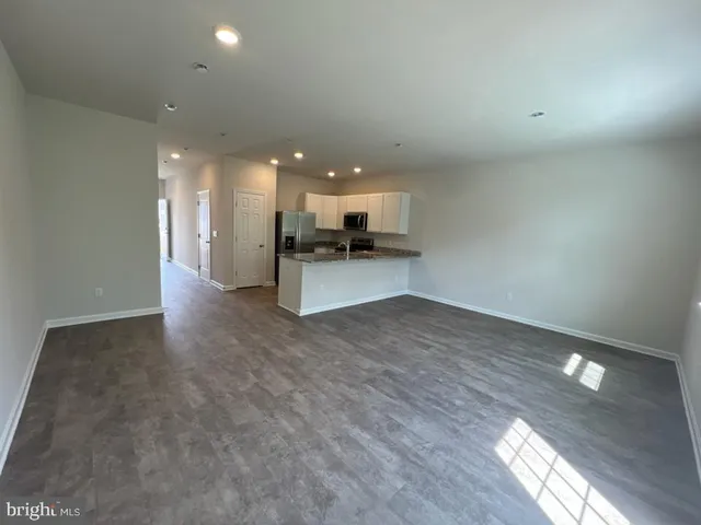 a view of a kitchen with a sink and a refrigerator