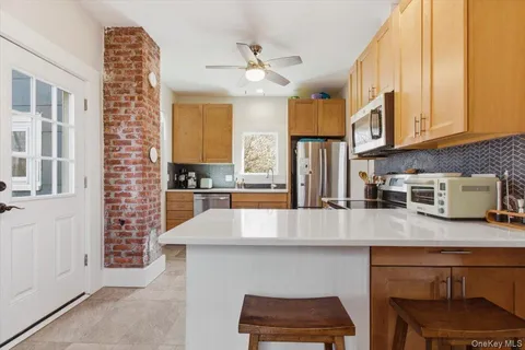 a kitchen with stainless steel appliances granite countertop a stove a sink and a refrigerator