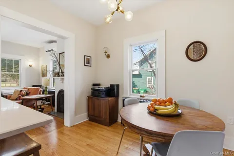a view of a dining room with furniture a chandelier and wooden floor