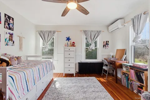 a bedroom with furniture and a rug