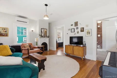 a living room with furniture a flat screen tv and a fireplace