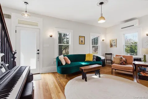 a living room with furniture and a piano