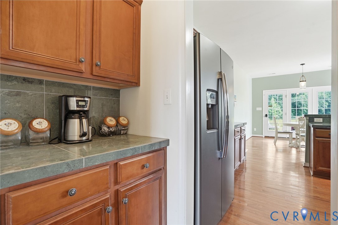 5305 Wellington Ridge Road Richmond, VA 23231 - Photo 15 of 67 Kitchen area featuring warm wood cabinetry, a dark