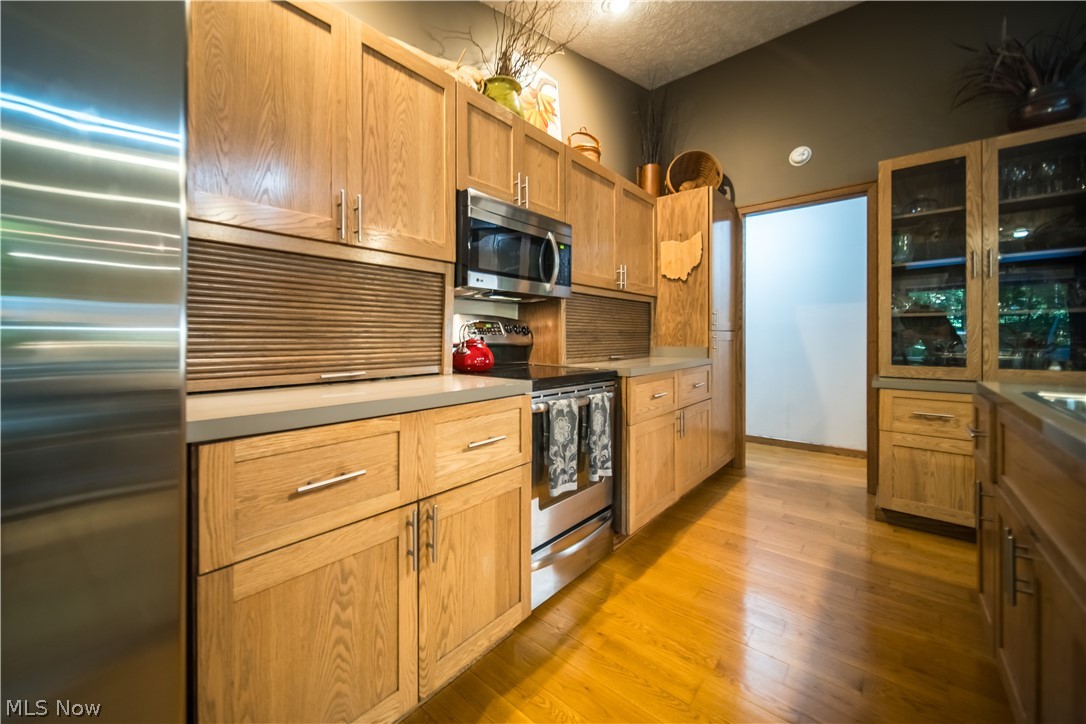 5119 Hattrick Road Ravenna, OH 44266 - Photo 13 of 33 Kitchen with appliances with stainless steel finishes and light hardwood / wood-style flooring