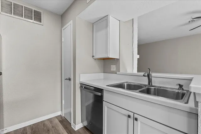 a kitchen with a sink and cabinets
