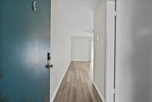 a view of a room with wooden floor