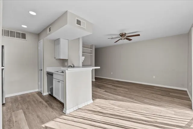 a view of kitchen with sink and wooden floor
