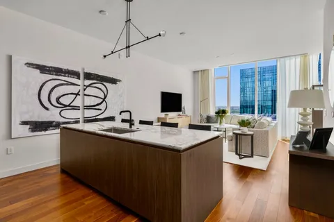 a kitchen with stainless steel appliances granite countertop a sink stove and wooden floor