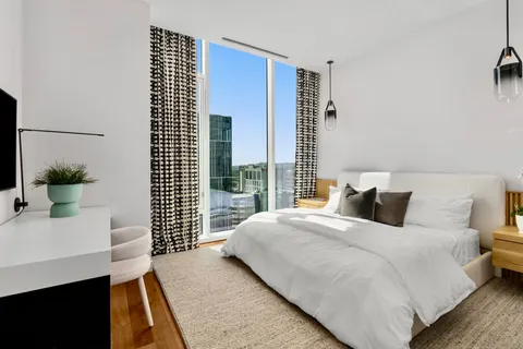 a bedroom with a bed and a potted plant