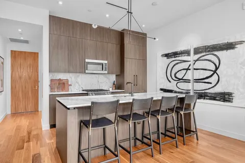 a kitchen that has a table and chairs in it
