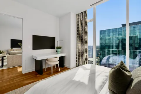a bedroom with a bed and a flat screen tv