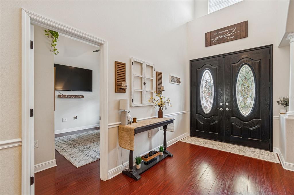 3077 Cork Road Plant City, FL 33565 - Photo 12 of 99 a living room with furniture a flat screen tv and a fireplace