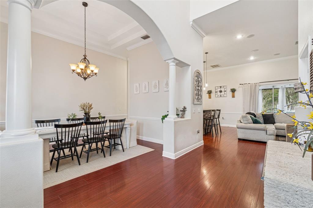 3077 Cork Road Plant City, FL 33565 - Photo 14 of 99 a view of a dining room with furniture wooden floor and chandelier