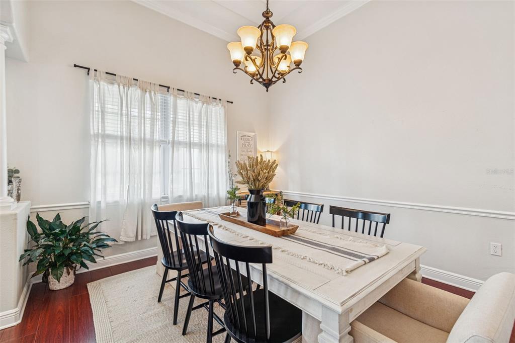 3077 Cork Road Plant City, FL 33565 - Photo 16 of 99 a view of a dining room with furniture window and wooden floor