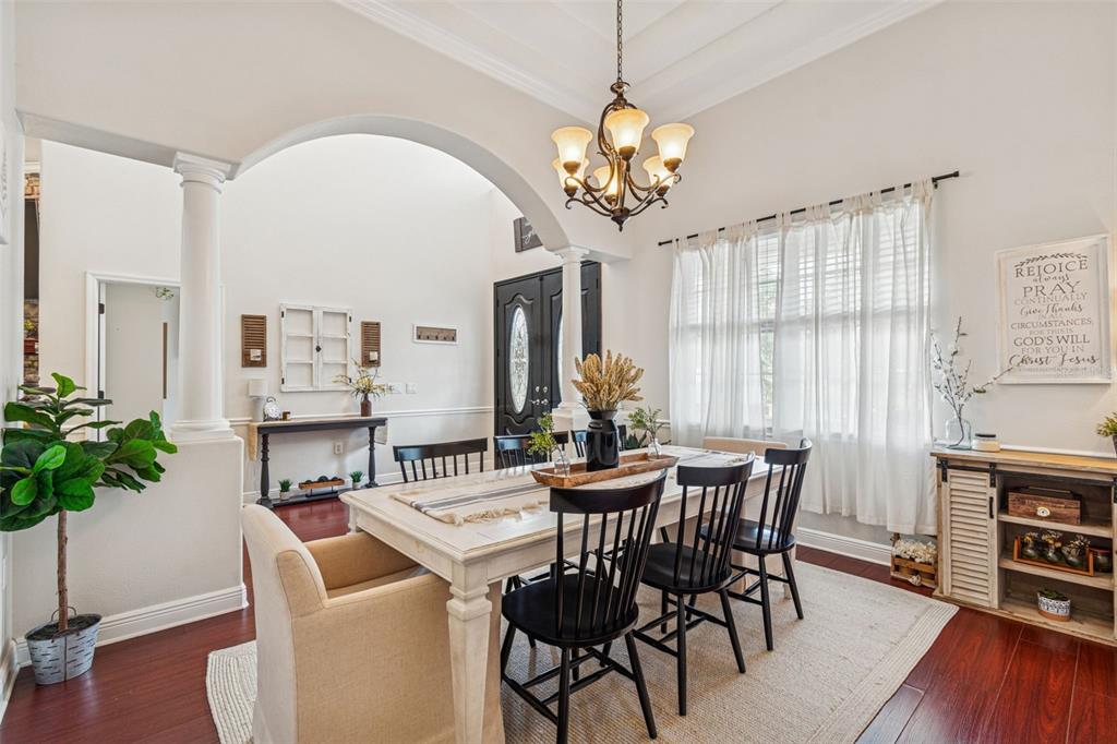 3077 Cork Road Plant City, FL 33565 - Photo 17 of 99 a view of a dining room with furniture window and wooden floor