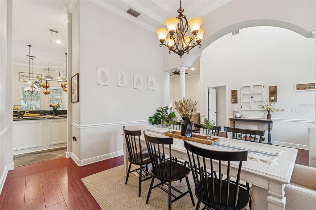 3077 Cork Road Plant City, FL 33565 - Photo 18 of 99 a view of a dining room with furniture and wooden floor