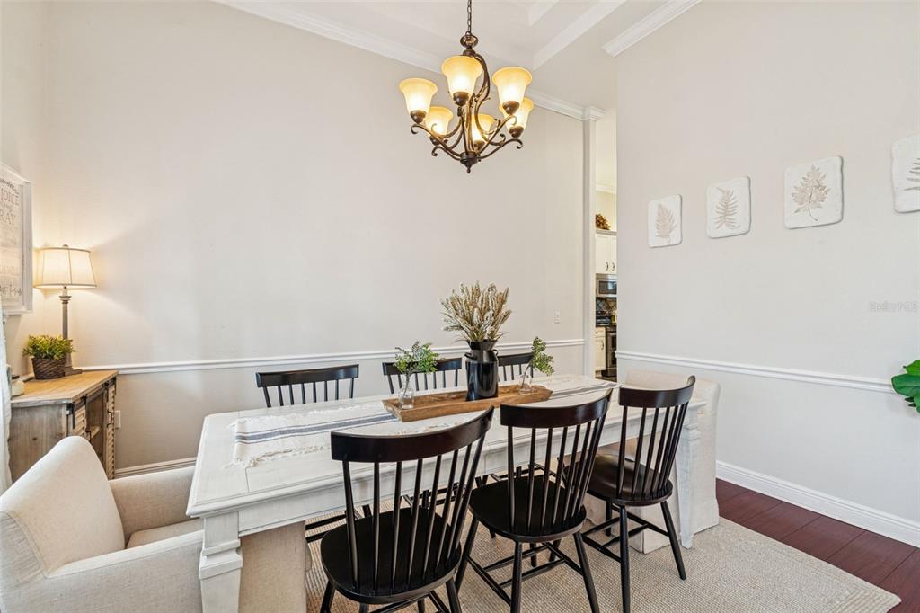 3077 Cork Road Plant City, FL 33565 - Photo 19 of 99 a view of a dining room with furniture and chandelier