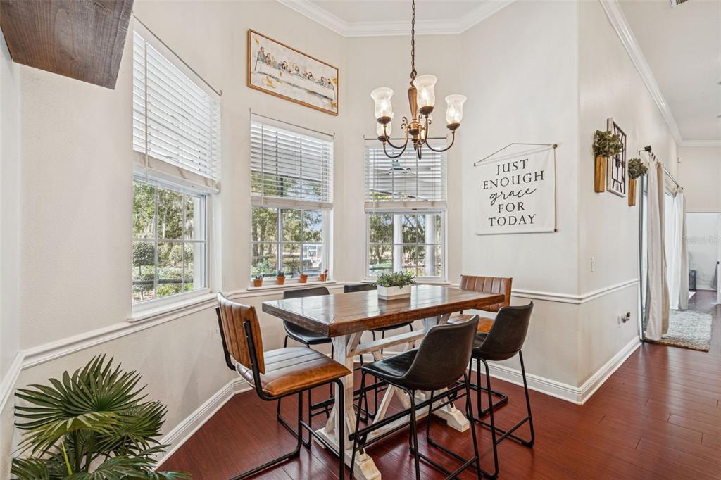3077 Cork Road Plant City, FL 33565 - Photo 31 of 99 a view of a dining room with furniture wooden floor and chandelier