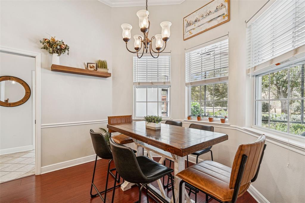 3077 Cork Road Plant City, FL 33565 - Photo 32 of 99 a view of a dining room with furniture a chandelier and wooden floor