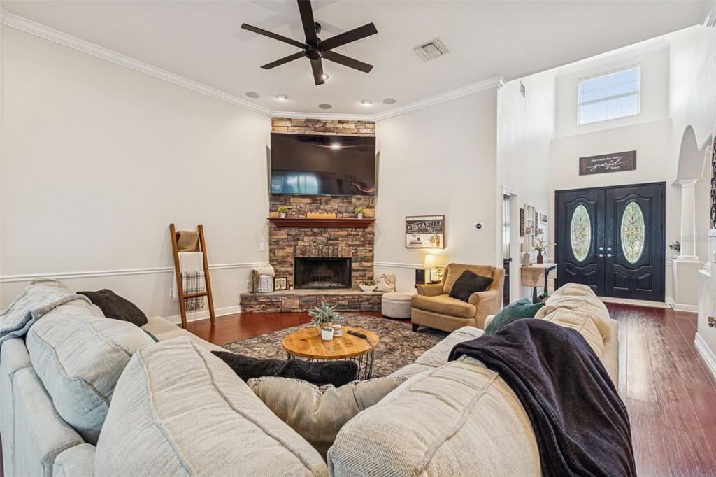 3077 Cork Road Plant City, FL 33565 - Photo 35 of 99 a living room with furniture and a fireplace