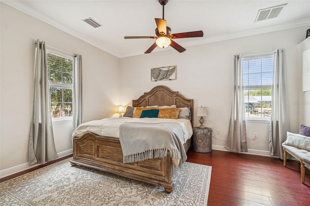 3077 Cork Road Plant City, FL 33565 - Photo 39 of 99 a bedroom with a bed and wooden floor