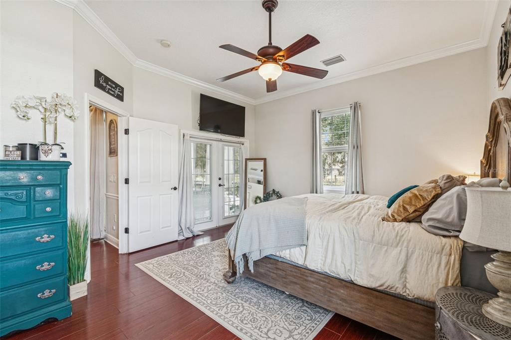 3077 Cork Road Plant City, FL 33565 - Photo 40 of 99 a bedroom with a bed and a chandelier