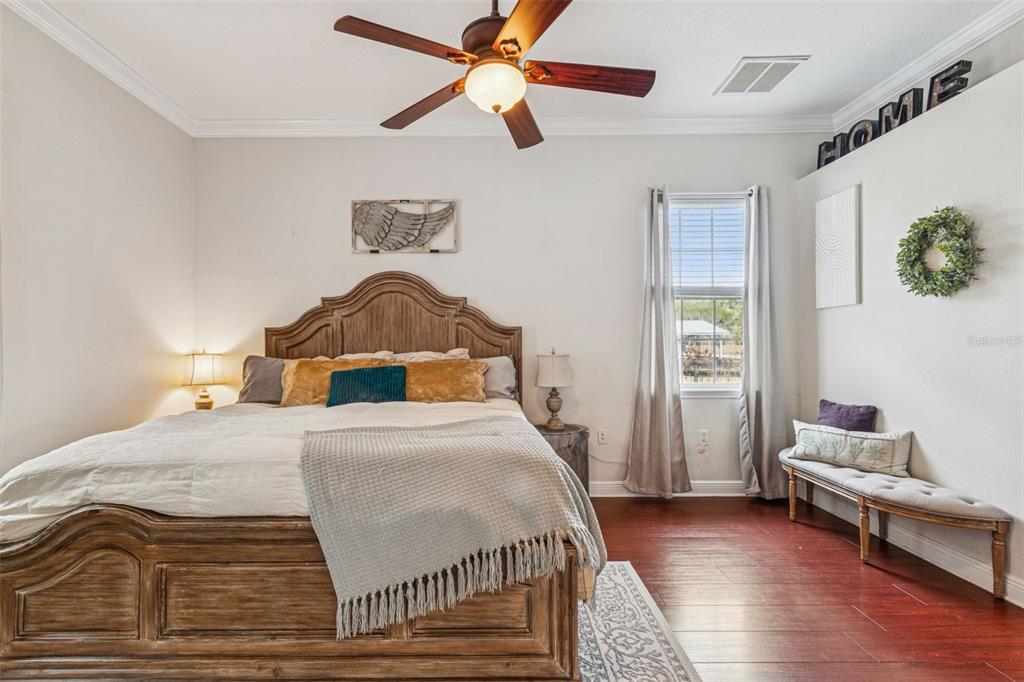 3077 Cork Road Plant City, FL 33565 - Photo 43 of 99 a bedroom with a bed and wooden floor