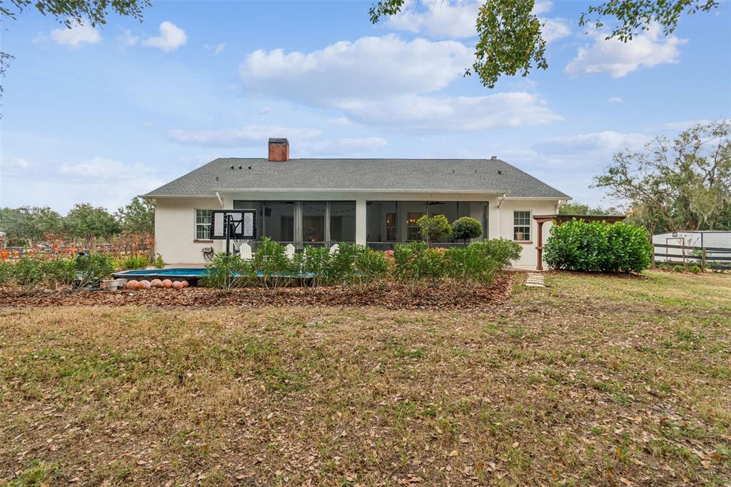 3077 Cork Road Plant City, FL 33565 - Photo 82 of 99 a front view of a house with a yard and potted plants