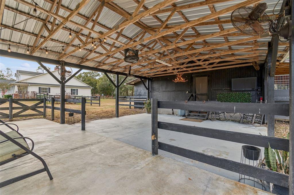 3077 Cork Road Plant City, FL 33565 - Photo 85 of 99 a view of a porch with furniture and a tree