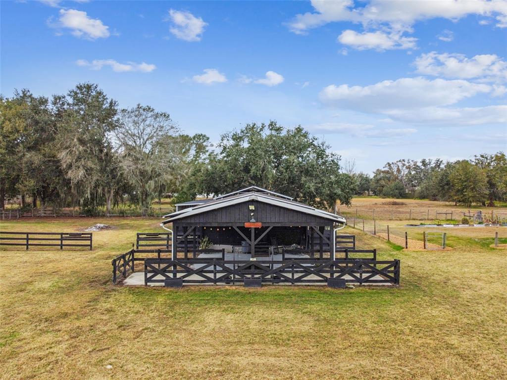 3077 Cork Road Plant City, FL 33565 - Photo 90 of 99 a view of a swimming pool with a table and chairs