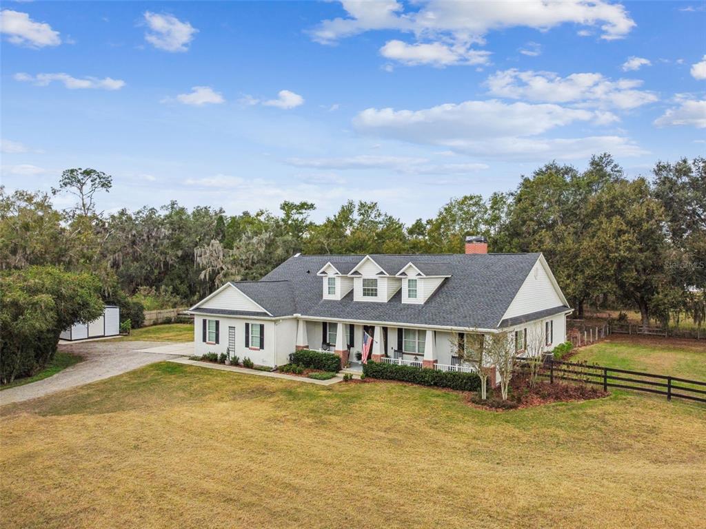 3077 Cork Road Plant City, FL 33565 - Photo 92 of 99 a front view of a house with a big yard and large trees