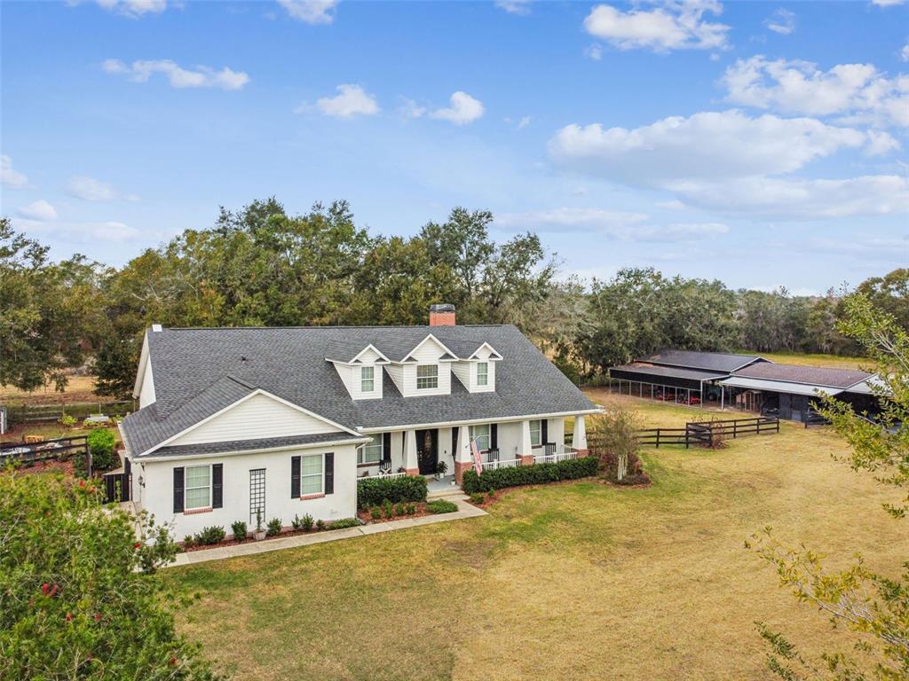 3077 Cork Road Plant City, FL 33565 - Photo 94 of 99 a front view of a house with a garden and lake view