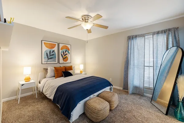 a bedroom with a bed and a chandelier