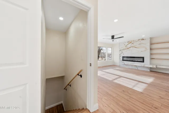 a view of entryway and hall with wooden floor