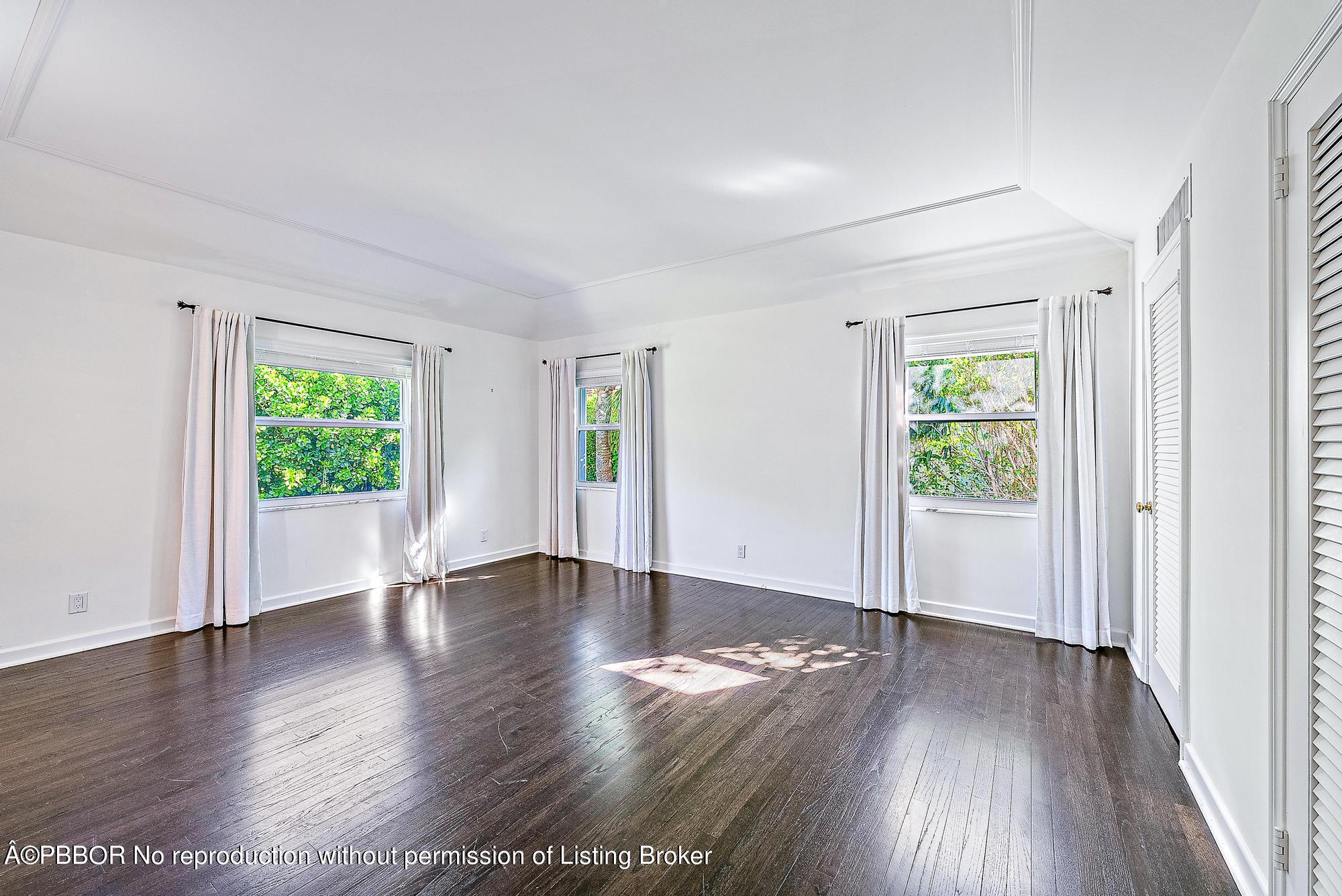 111 Reef Road Palm Beach, FL 33480 - Photo 11 of 28 an empty room with wooden floor and windows