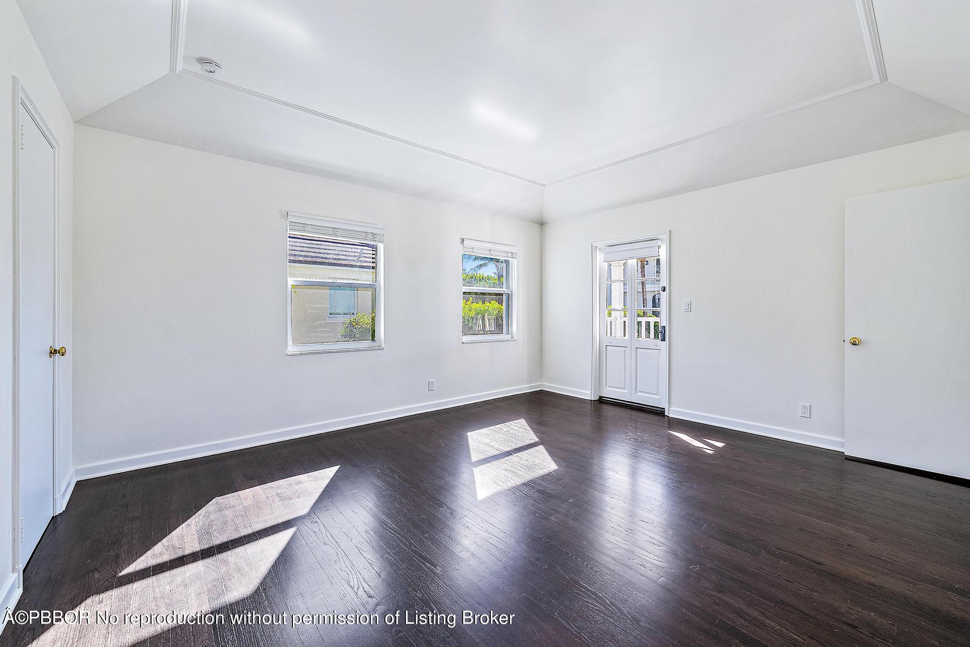 111 Reef Road Palm Beach, FL 33480 - Photo 15 of 28 an empty room with wooden floor and windows